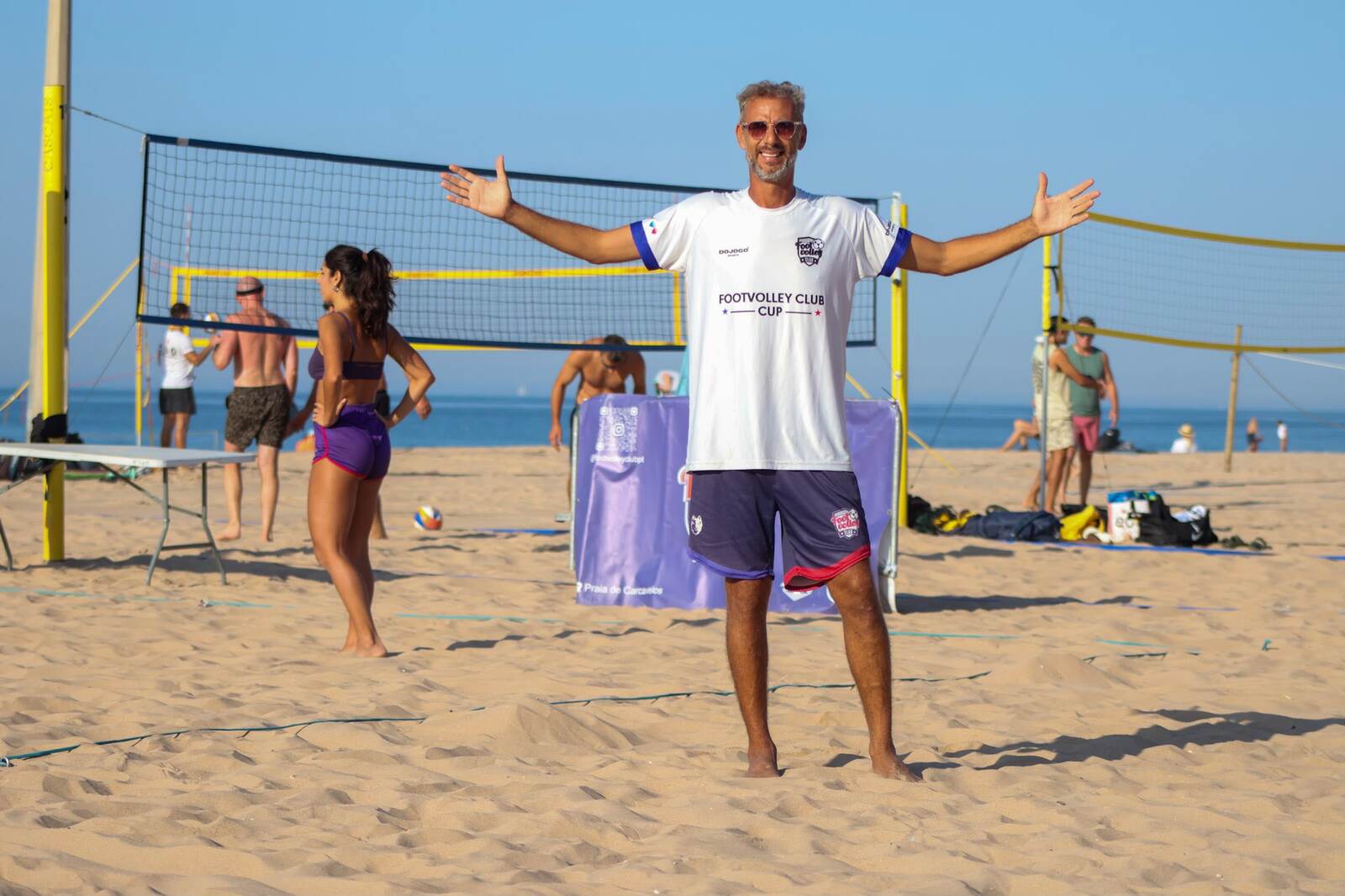 Erick Kretzu on the beach in a Footvolley Club Cup shirt