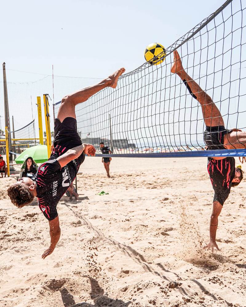 Player in an acrobatic overhead kick at the net