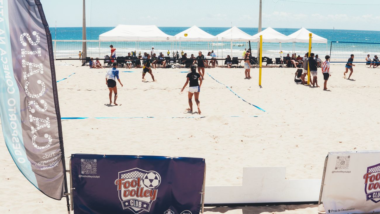 Match on the courts at the Footvolley Club tournament with banners and tents